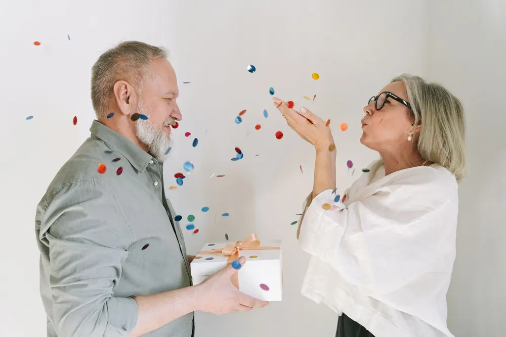 Pareja celebrando entre confeti, tazas personalizadas para un día especial en San Cristóbal